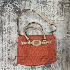 Michael Kors tangerine medium sized purse with shoulder strap and handles.